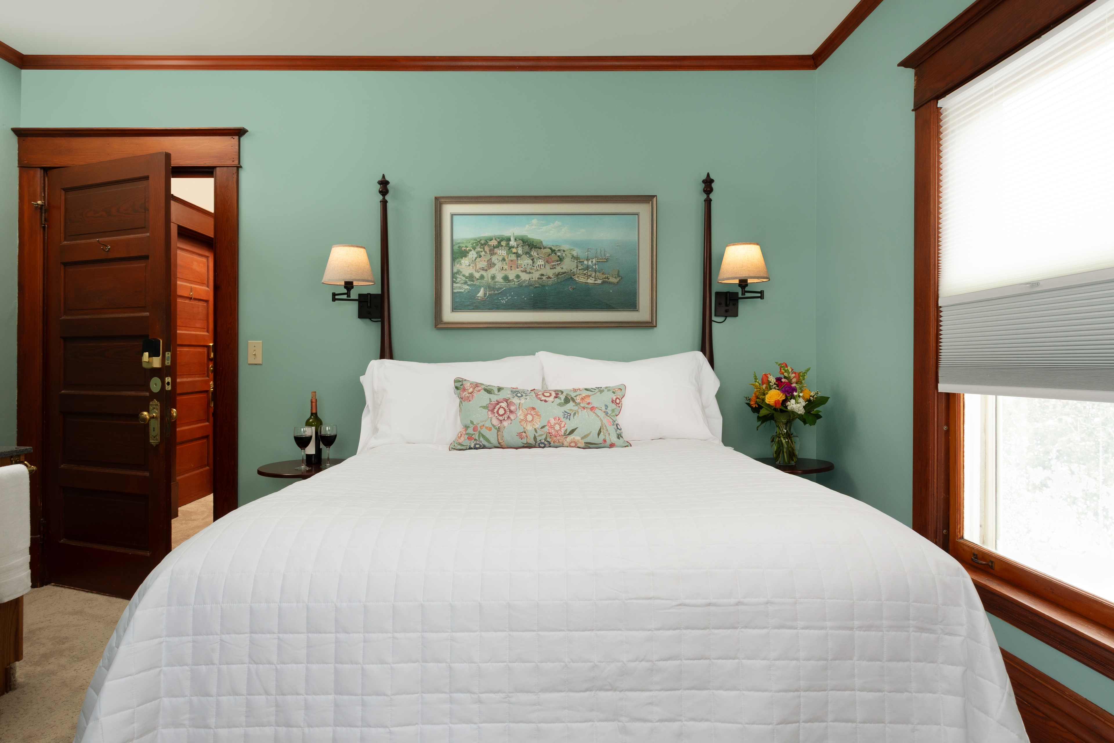 Room 2 with a Queen bed, fireplace, 2 poster bed and wall sconces.