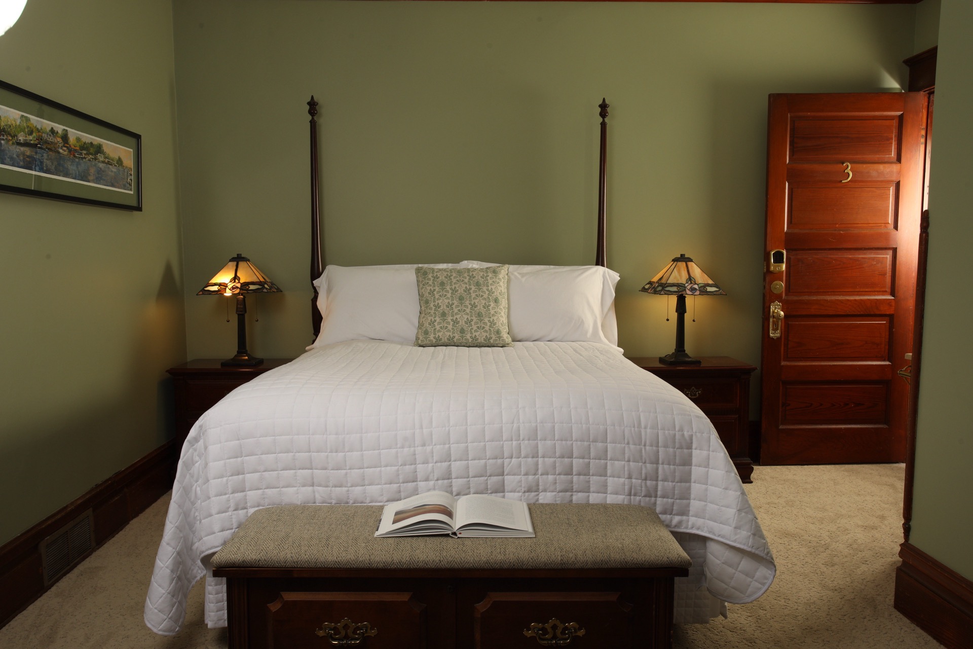 Bedroom with Clary Sage walls, a fireplace, and a sink vanity facing Butler Street.