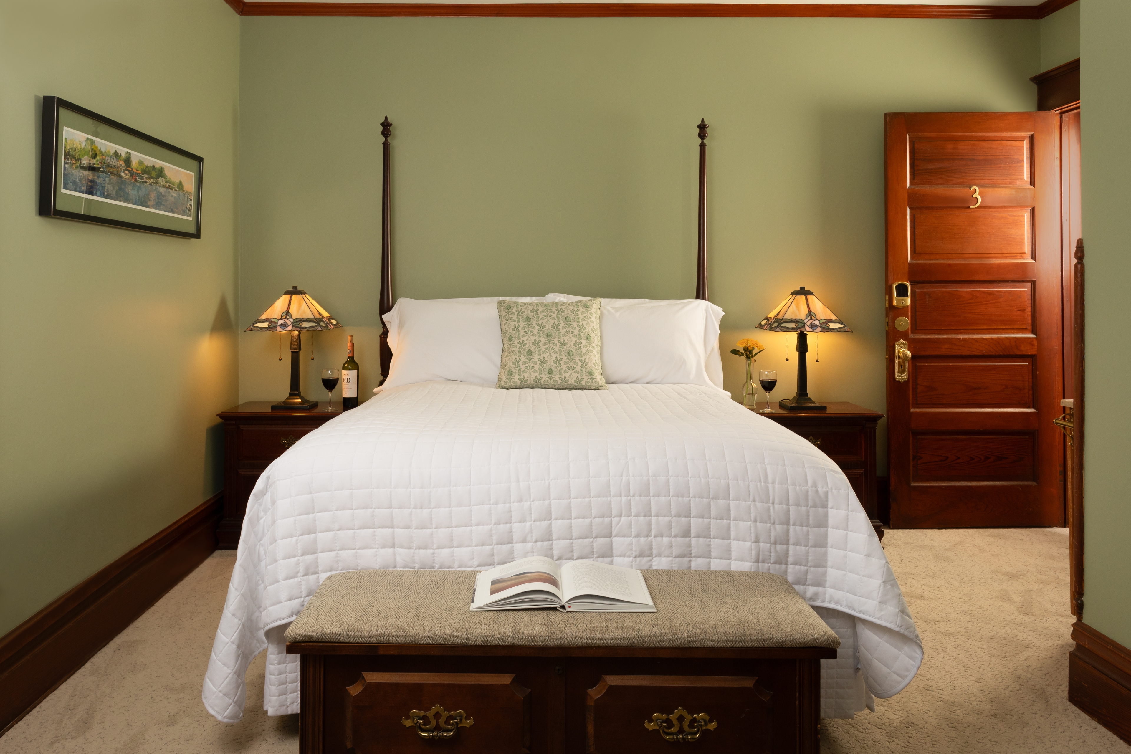 Bedroom with Clary Sage walls, a fireplace, and a sink vanity facing Butler Street.