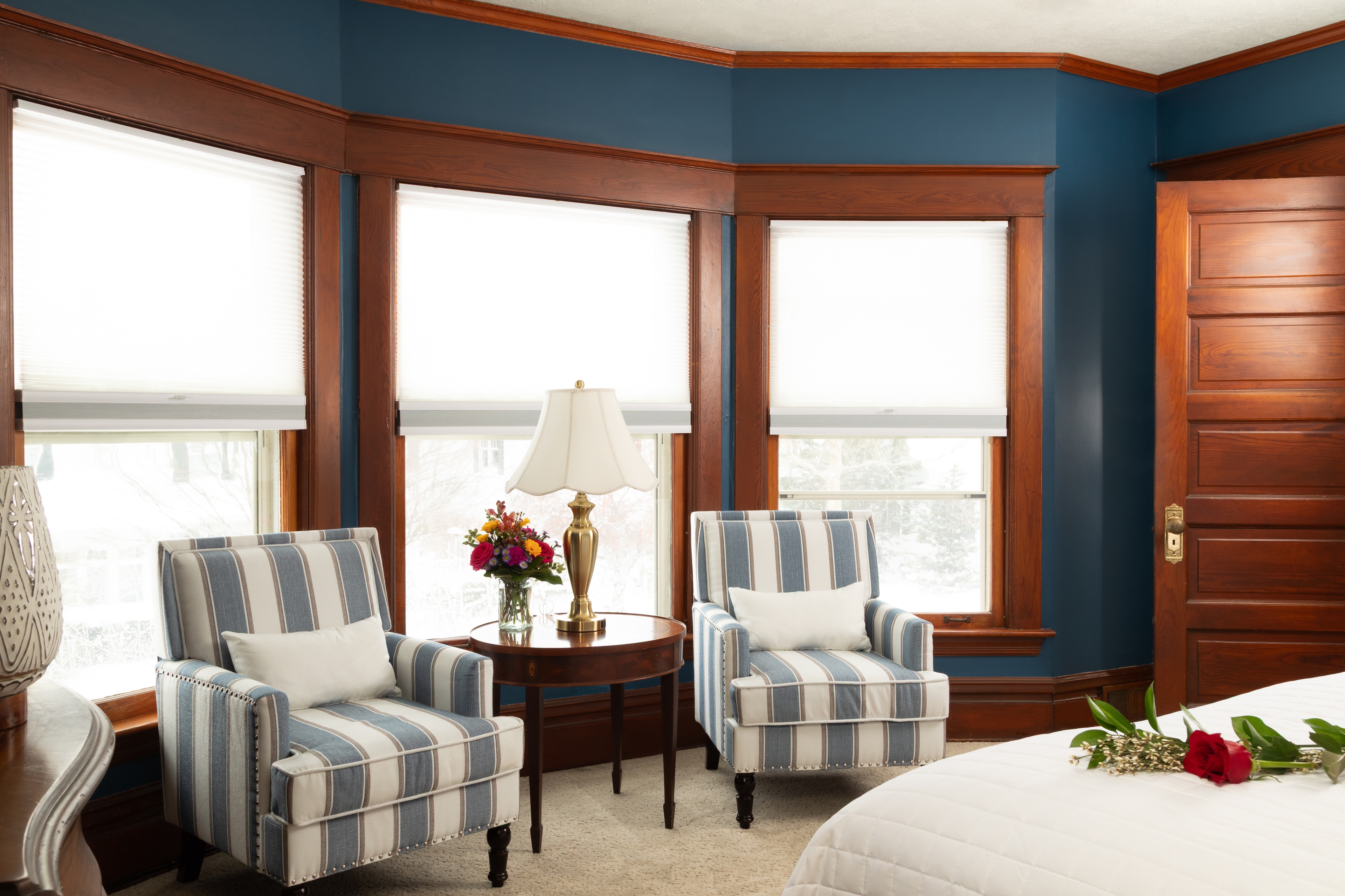 Our 2nd largest bedroom with endless sea walls, a King bed, two armchairs , and a television.