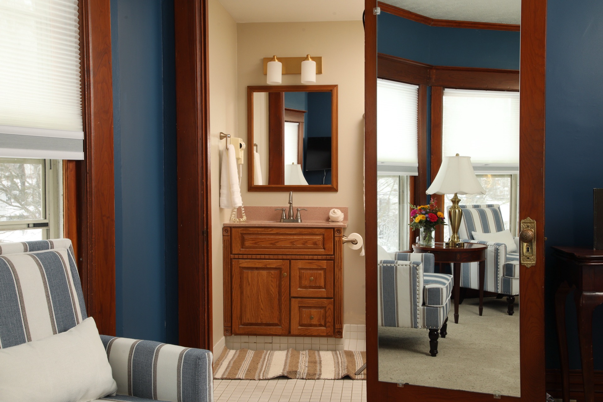 Our 2nd largest bedroom with endless sea walls, a King bed, two armchairs , and a television.