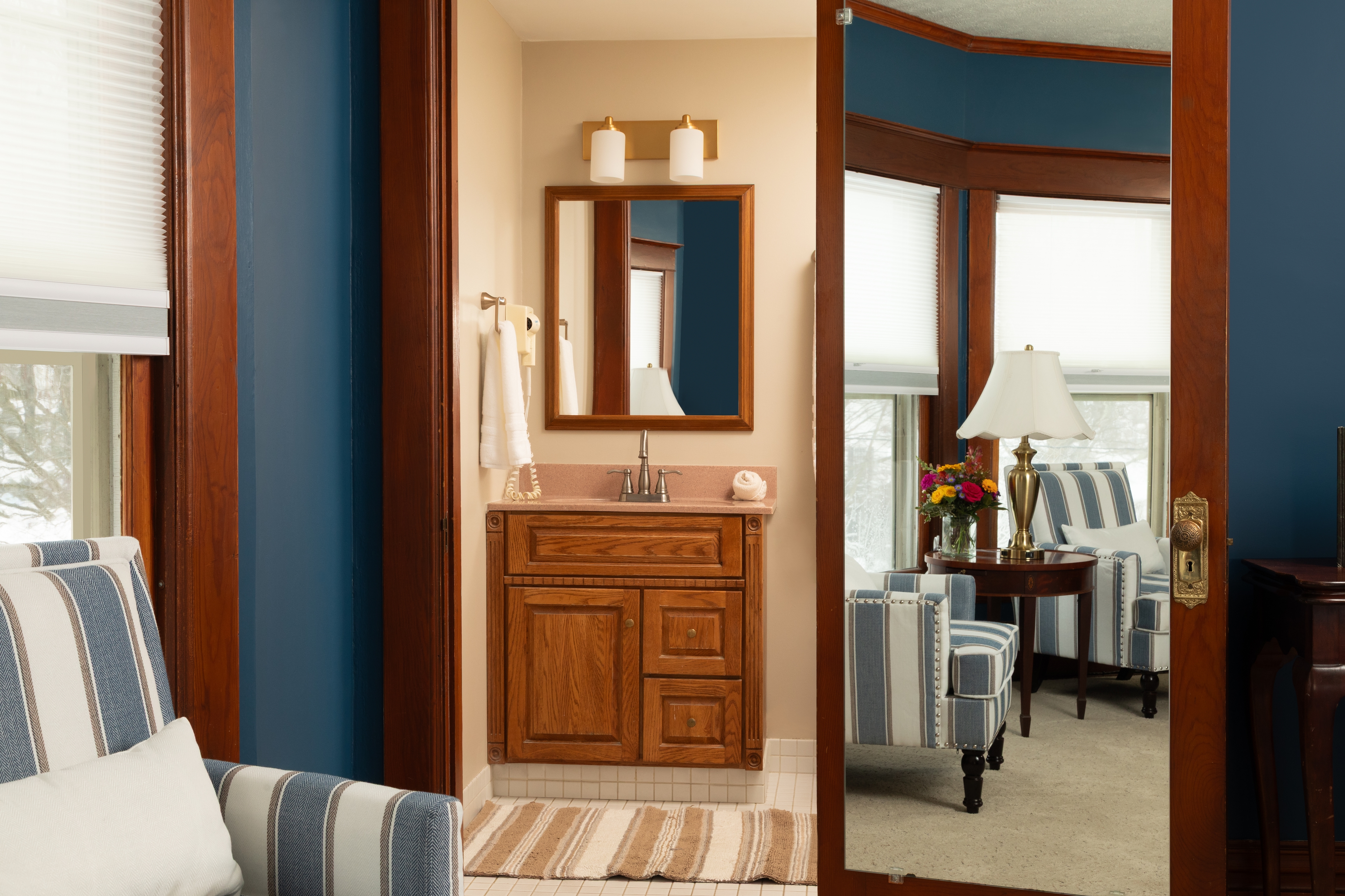 Our 2nd largest bedroom with endless sea walls, a King bed, two armchairs , and a television.