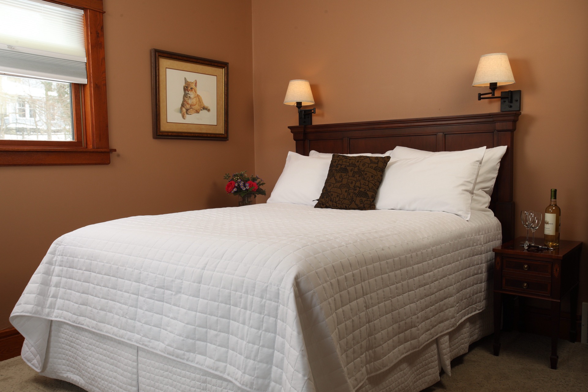 Bedroom with Queen bed, a fireplace, and Rose Renwick painted walls.