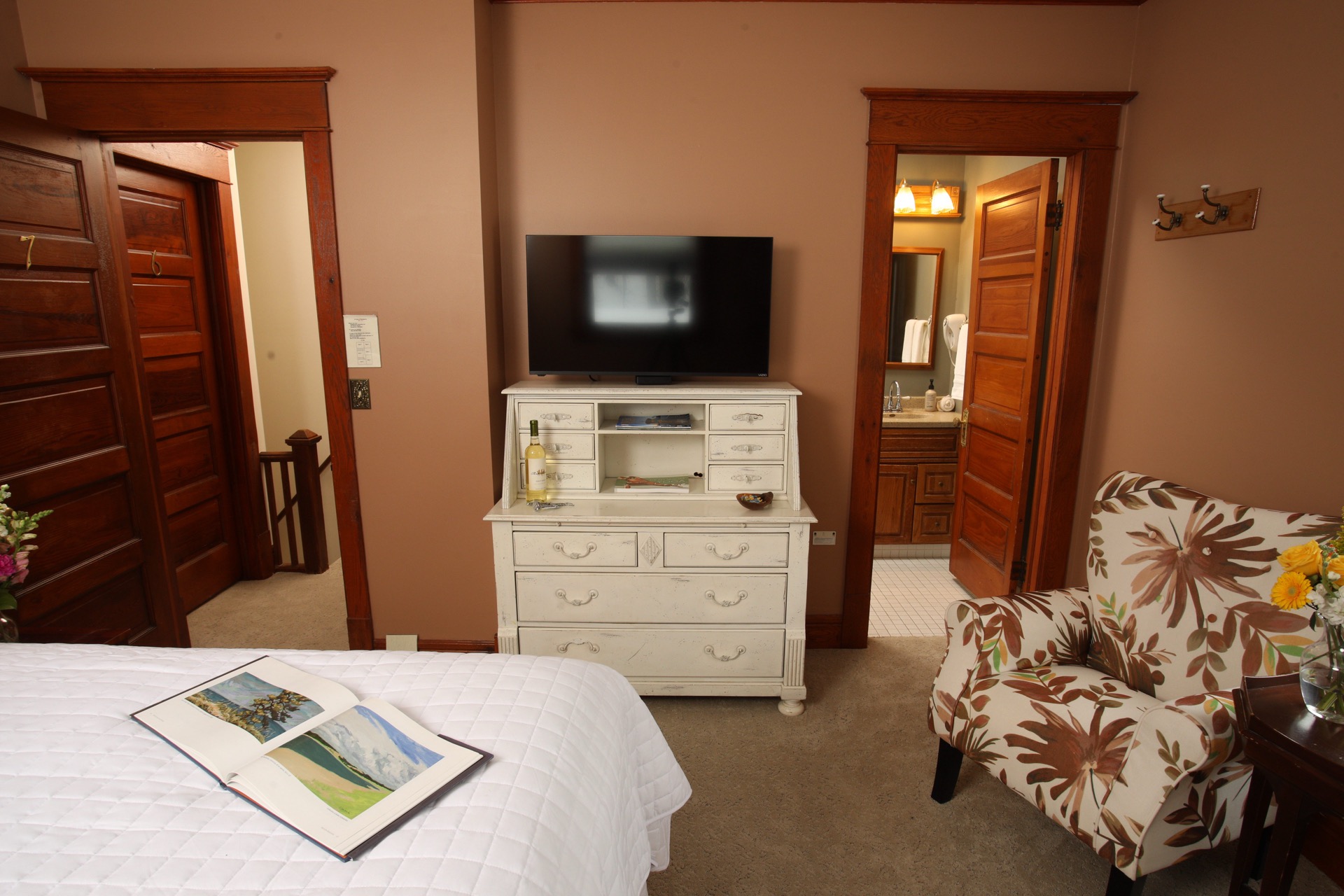 Bedroom with Queen bed, a fireplace, and Rose Renwick painted walls.