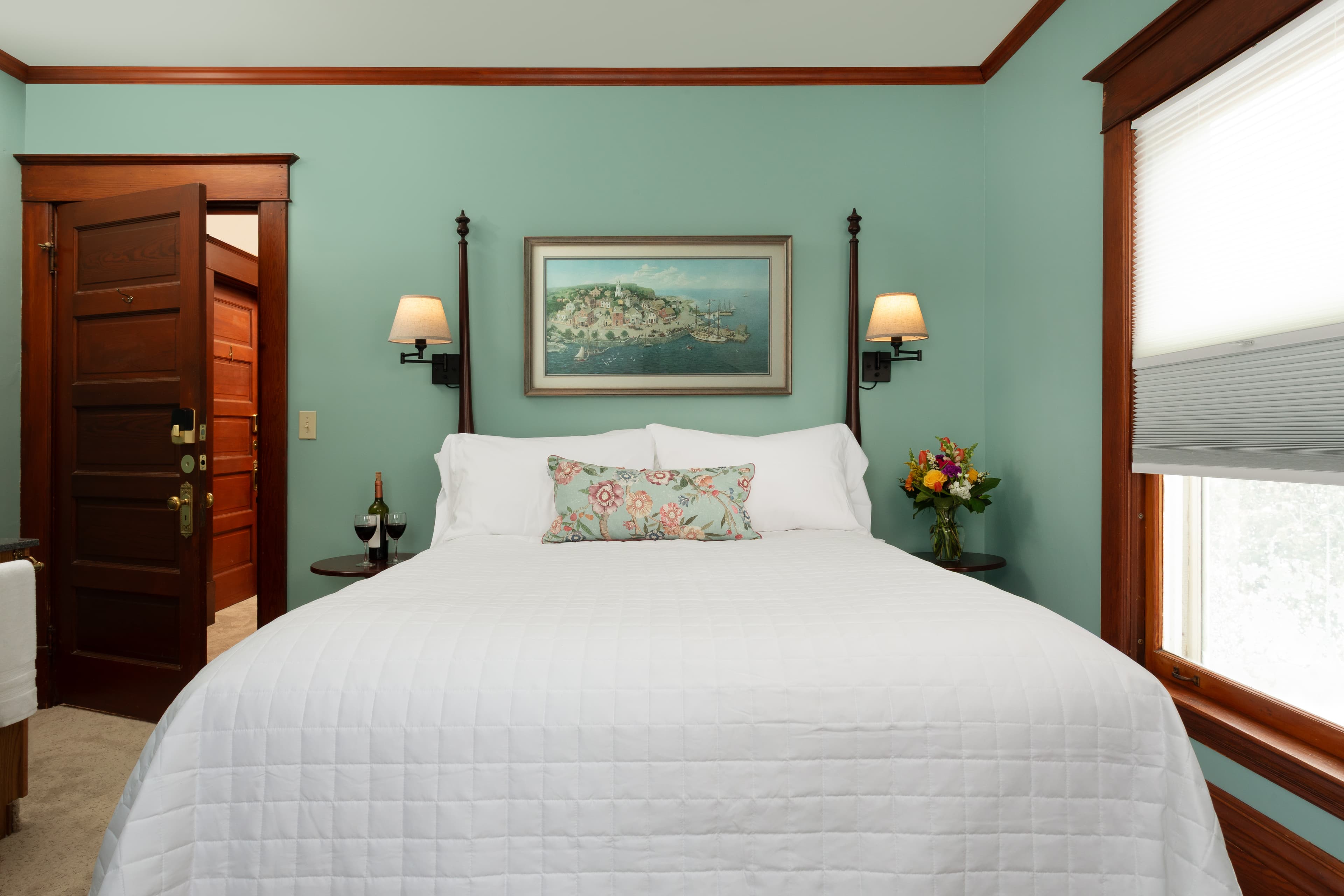 Room 2 with a Queen bed, fireplace, 2 poster bed and wall sconces.