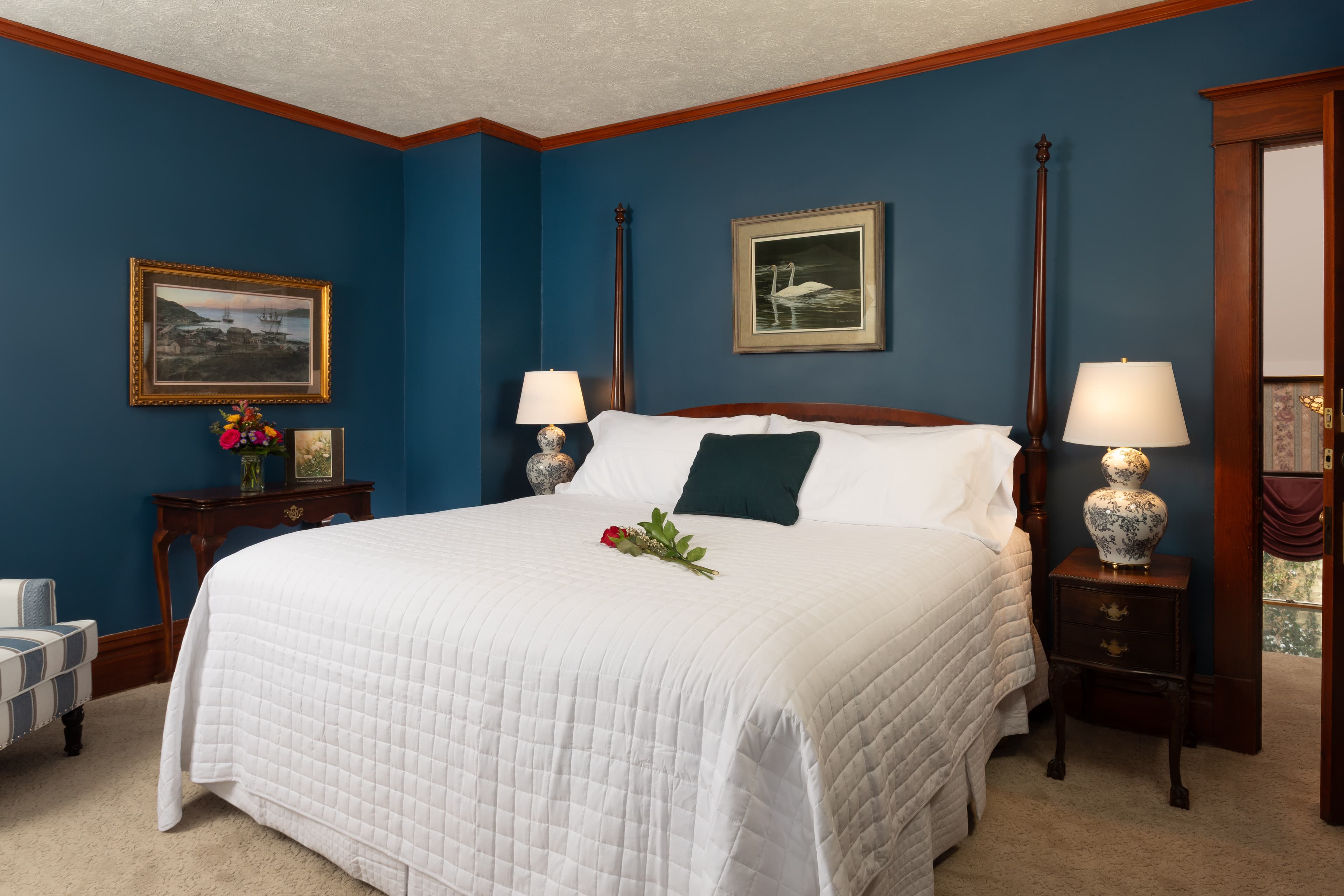 Our 2nd largest bedroom with endless sea walls, a King bed, two armchairs , and a television.