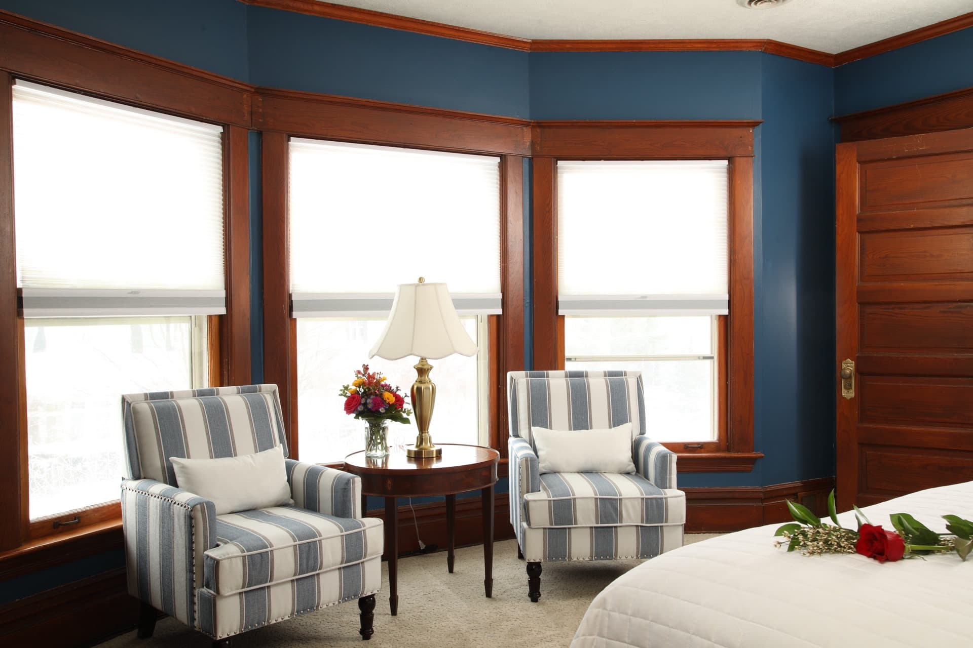 Our 2nd largest bedroom with endless sea walls, a King bed, two armchairs , and a television.