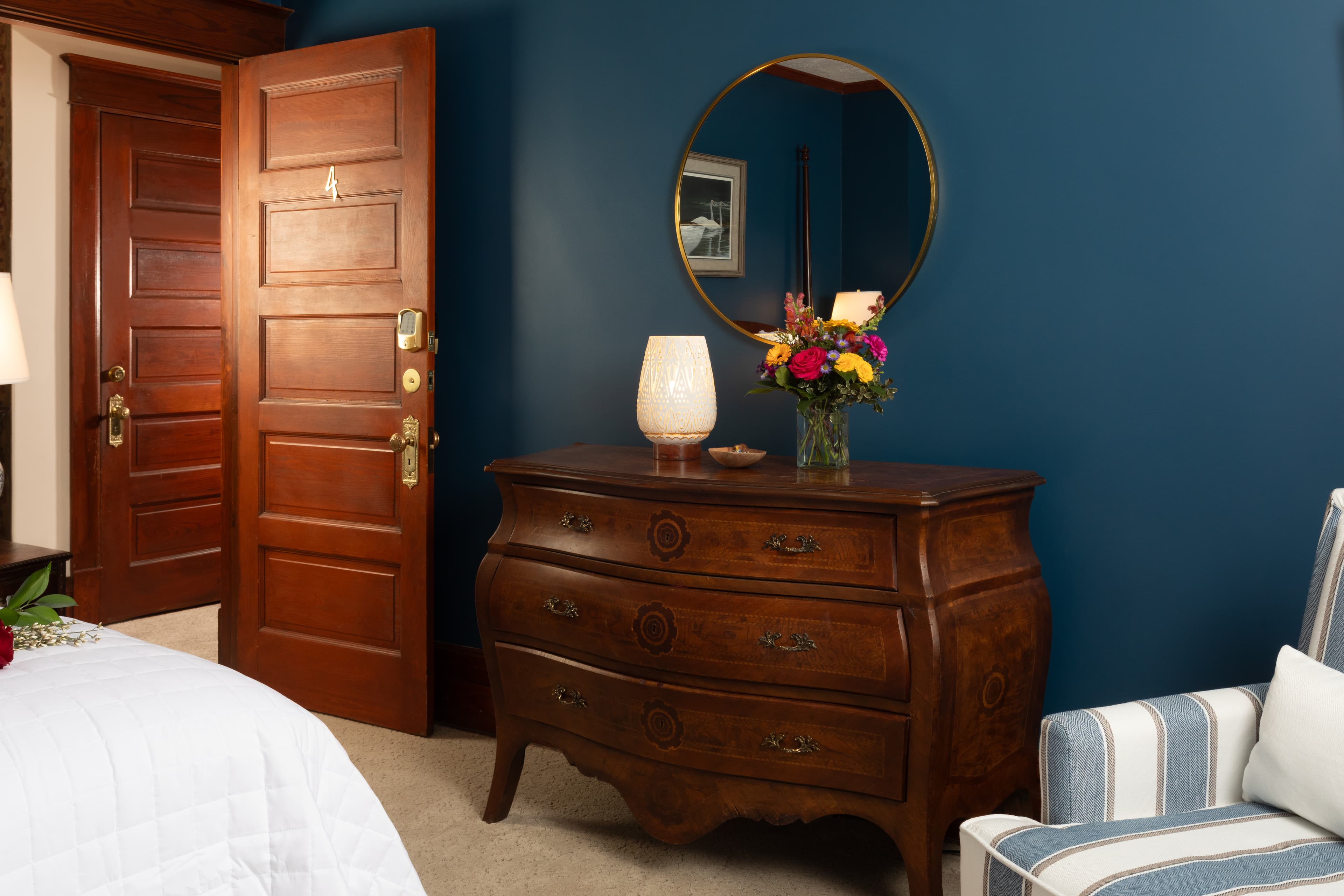 Our 2nd largest bedroom with endless sea walls, a King bed, two armchairs , and a television.