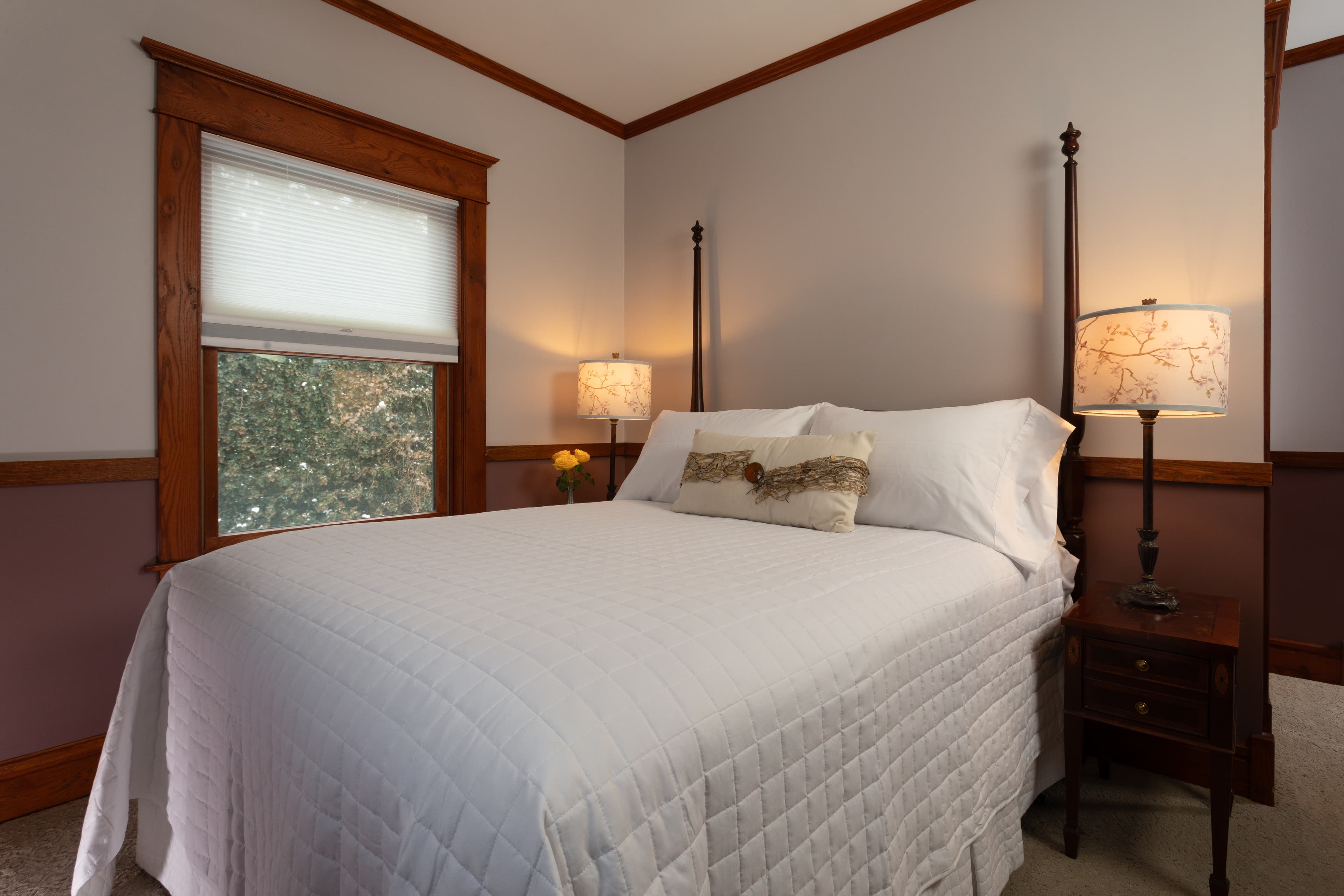 Two tone bedroom with a 2 post Heckman bed,  a fireplace, and a flat-screen TV.