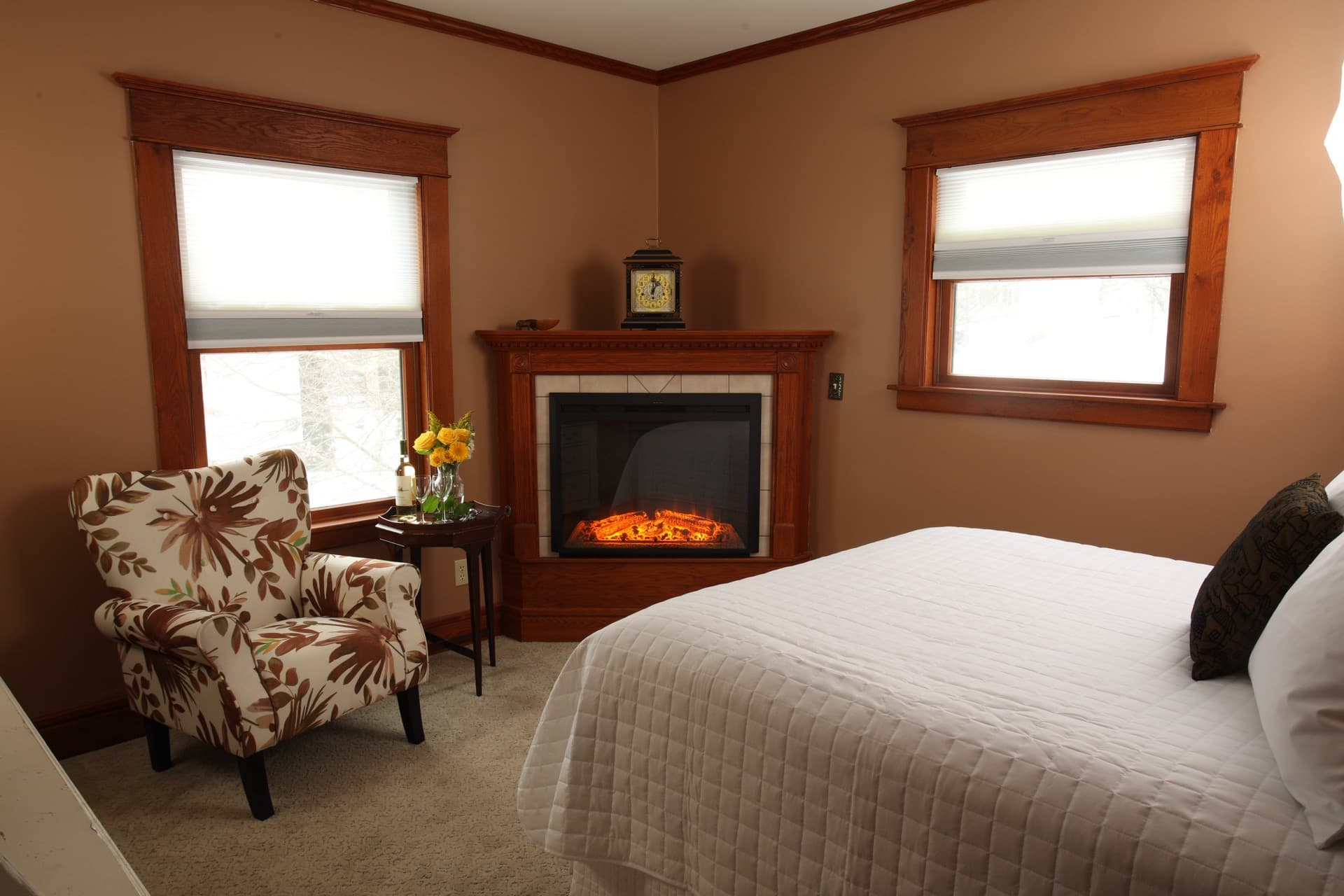 Bedroom with Queen bed, a fireplace, and Rose Renwick painted walls.