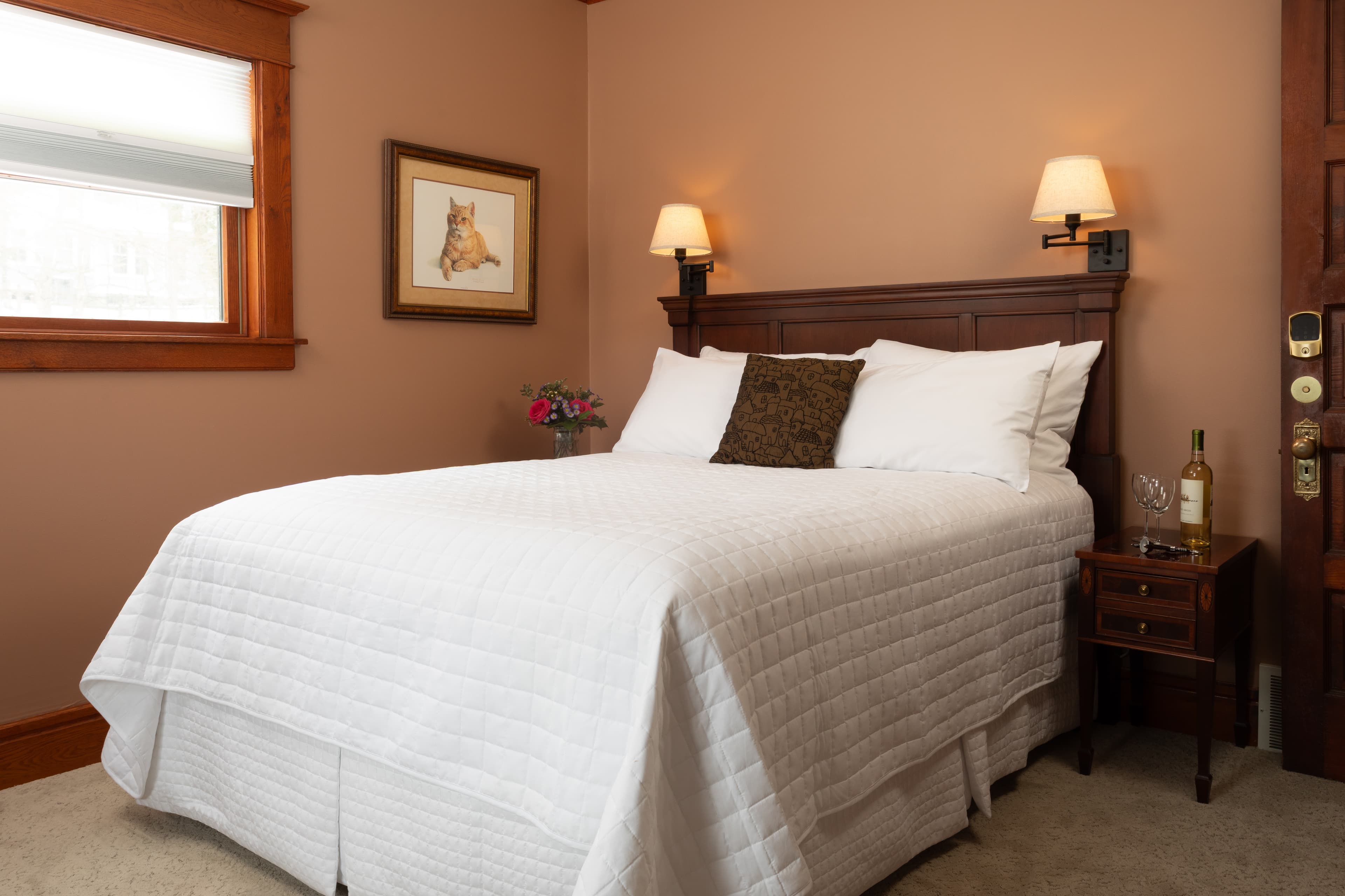 Bedroom with Queen bed, a fireplace, and Rose Renwick painted walls.